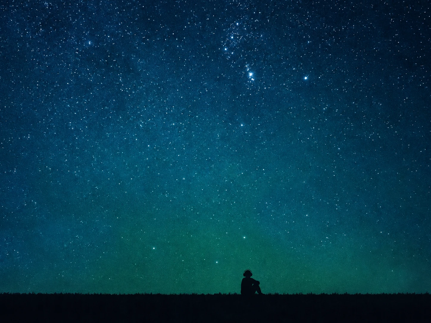 A single small black silhouette seated alone on the horizon beneath a vast starry sky, headphones on, knees drawn up