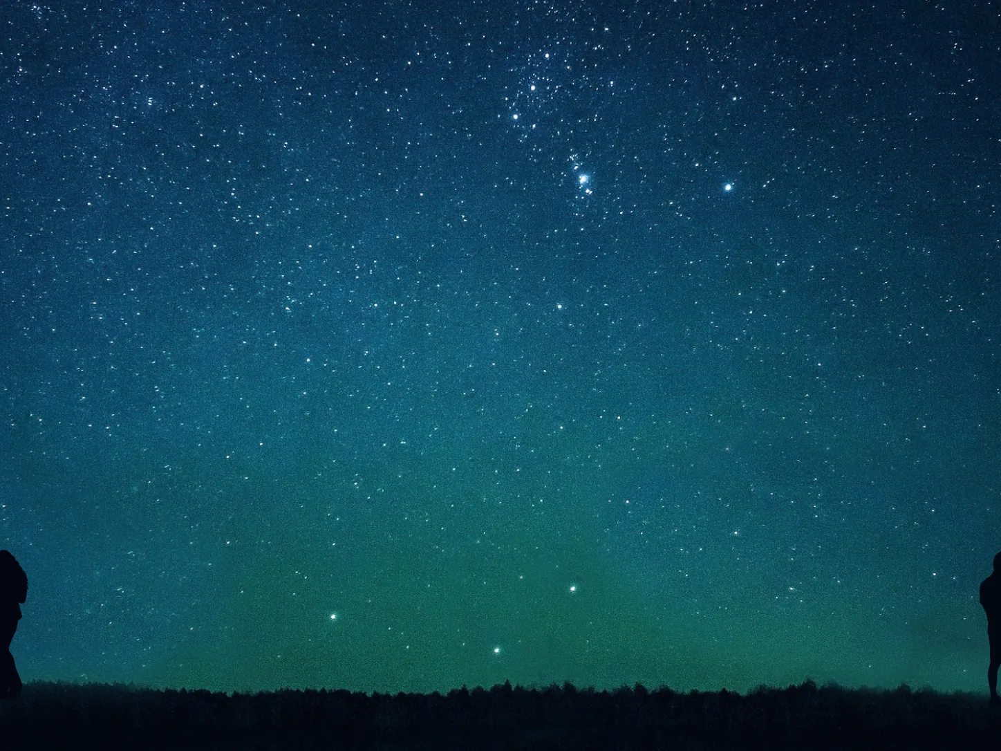 Two distant silhouettes looking at their phones beneath the same star-filled sky